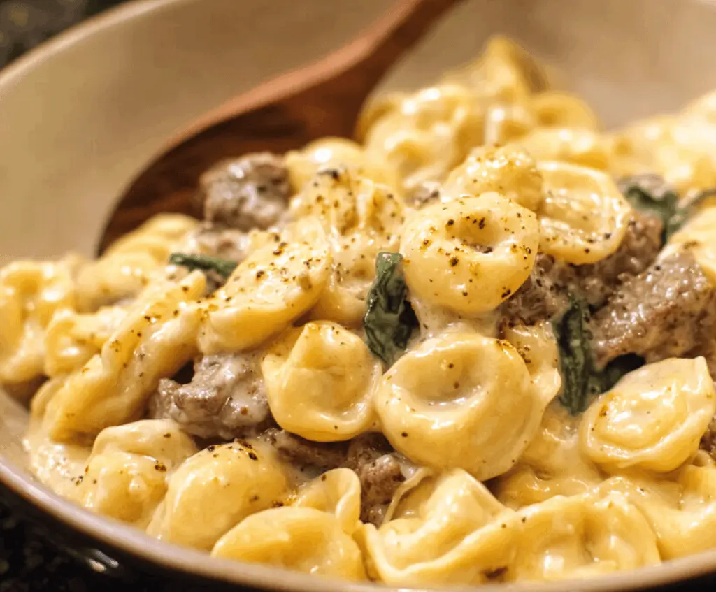 Delicious garlic butter beef and spinach tortellini dish served on a plate, featuring tender tortellini pasta, sautéed spinach, and savory beef in a flavorful garlic butter sauce