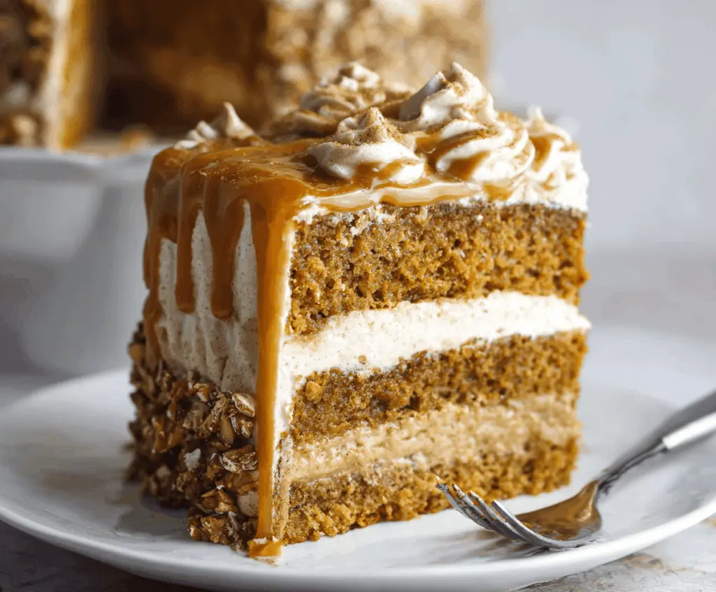 Delicious Pumpkin Spice Latte Cake topped with whipped cream and cinnamon, perfect for fall celebrations.