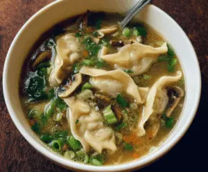 A bowl of easy potsticker soup with steaming broth, vegetables, and golden potstickers, perfect for comfort food lovers.